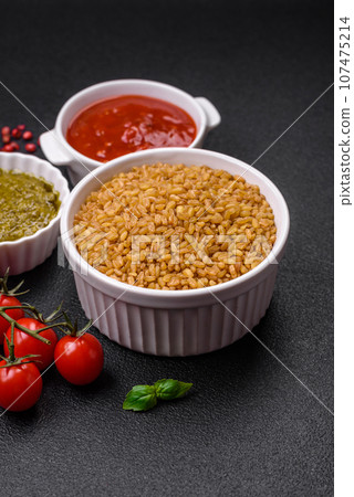 Raw bulgur wheat porridge as an ingredient for preparing a delicious dish 107475214
