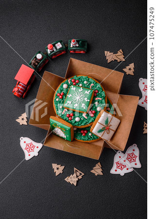 Beautiful festive Christmas gingerbread made by hand with decoration elements Beautiful festive Christmas gingerbread made by hand with decoration elements 107475249
