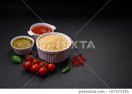 Raw whole grain orzo pasta as an ingredient for a delicious dish Raw whole grain orzo pasta as an ingredient for a delicious dish 107475265