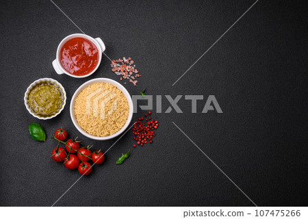 Raw whole grain orzo pasta as an ingredient for a delicious dish Raw whole grain orzo pasta as an ingredient for a delicious dish 107475266