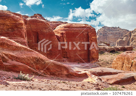 View of the Temples and caves carved into the sandstone rock in the gorge. Petra, Jordan 107476261