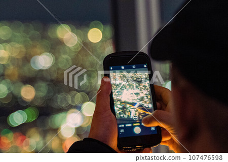 A person shooting illuminations 107476598