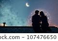 A married couple is sitting on the roof of a house at night. valentines day 107476650