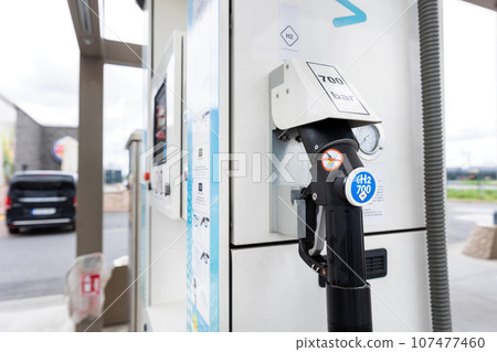 Close-up detail view of hydrogen fuel filler nozzle nozzle adapter car H2 gas filling station in Germany. Refueling vehicle with renewable innovative zero emission product. Future safety technology Close-up detail view of hydrogen fuel filler nozzle nozzle adapter car H2 gas filling station in Germany. Refueling vehicle with renewable innovative zero emission product. Future safety technology 107477460