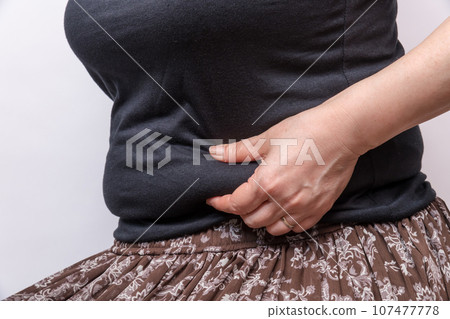 [Housewife picking meat from her belly] 107477778