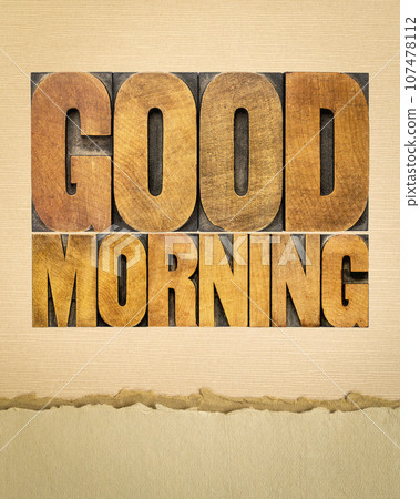 Good morning word abstract in vintage letterpress wood type against art paper 107478112