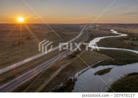 sunrise over a river meandering through Nebraska Sandhills, highway and railroad - aerial view of Middle Loup River near Halsey sunrise over a river meandering through Nebraska Sandhills, highway and railroad - aerial view of Middle Loup River near Halsey 107478117