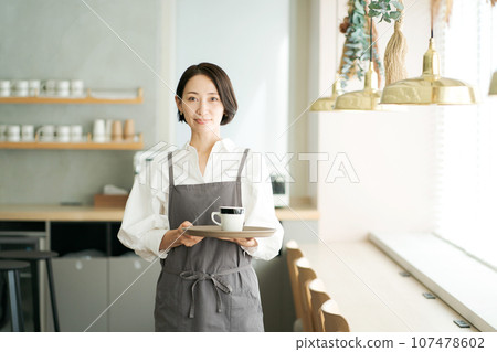 A woman working in a cafe A woman working in a cafe 107478602