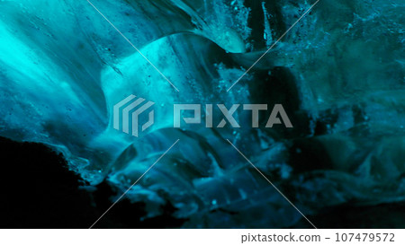 Vatnajokull glacier hiking in crevasse, nordic landscape inside ice cave with blue ice rocks. Frosty polar icebergs with cracked frozen structure, icelandic freezing cold destination . Handheld shot. Vatnajokull glacier hiking in crevasse, nordic landscape inside ice cave with blue ice rocks. Frosty polar icebergs with cracked frozen structure, icelandic freezing cold destination . Handheld shot. 107479572