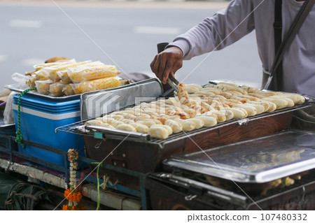 Grilled bananas are sold and prepared on the streets 107480332