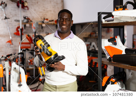 Man deciding on best submersible pump in garden equipment shop Man deciding on best submersible pump in garden equipment shop 107481380