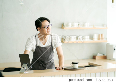 A man working at a cafe A man working at a cafe 107482795