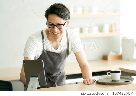 A man working at a cafe A man working at a cafe 107482797
