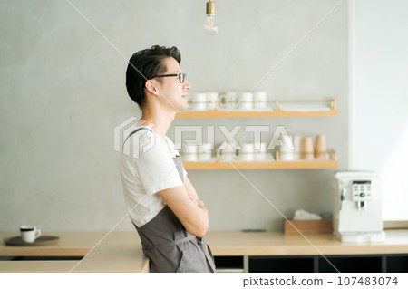 man folding his arms in the kitchen man folding his arms in the kitchen 107483074