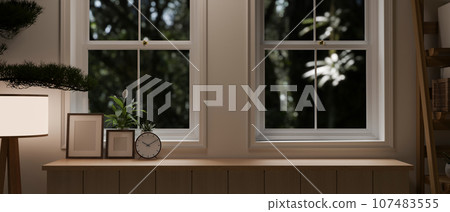 Empty space on a wooden tabletop or drawer against the window in a minimalist living room. Empty space on a wooden tabletop or drawer against the window in a minimalist living room. 107483555