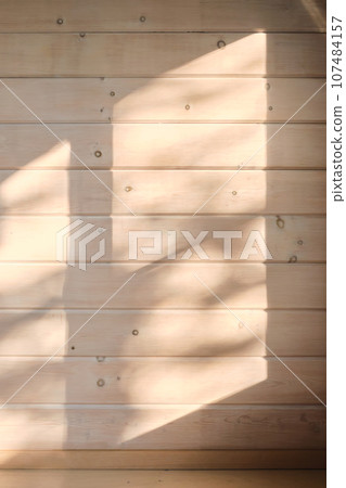 Sun glare on a wooden wall. 107484157