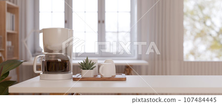 White minimal coffee table with coffee machine and coffee cup on the table. 107484445