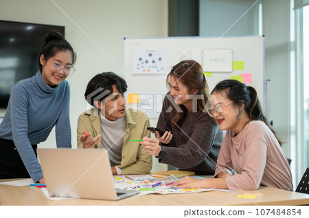 Team of young professional UX/UI designer working together in the meeting room. Team of young professional UX/UI designer working together in the meeting room. 107484854