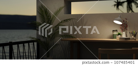 Modern workspace at night, copy space on a table and balcony with a beautiful sunset view 107485401