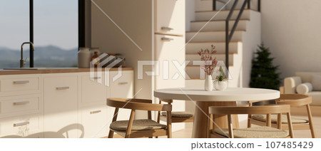 A beautiful minimal dining table in a minimal white Scandinavian kitchen design. 107485429