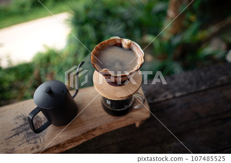 Closeup of hands make coffee at home 107485525