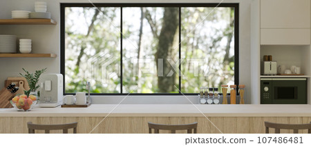 Copy space on a minimal white kitchen countertop in a modern white kitchen. Copy space on a minimal white kitchen countertop in a modern white kitchen. 107486481