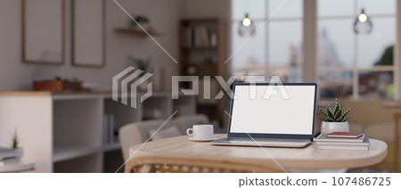 Close-up image of a laptop mockup on a table in a modern cozy room. 107486725