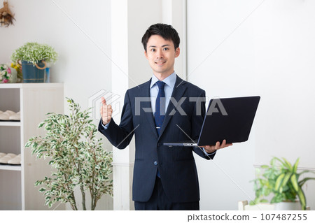 Businessman with a laptop Businessman with a laptop 107487255