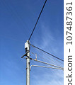 Telephone poles and wires under the blue sky 107487361