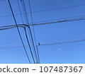 Telephone poles and wires under the blue sky 107487367
