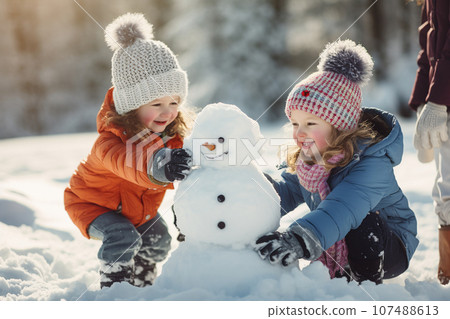 Children building a snowman together on winter day. Kids smiling and having fun while playing in snow outdoors. Generative AI. 107488613