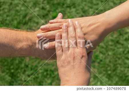 Joined hands as a team. Business teamwork. Close up group of multiracial friends meeting join hands together. Diversity people. Partnership volunteer community. Diverse multiethnic Partners. Top View Joined hands as a team. Business teamwork. Close up group of multiracial friends meeting join hands together. Diversity people. Partnership volunteer community. Diverse multiethnic Partners. Top View 107489078