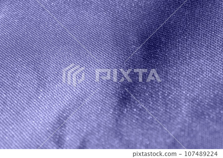 Very Peri. Color of the year 2022. Fabric Texture. Macro. Abstract Pattern of Textile. Close Up. Denim. Background with Textured Material and Polyester Structure. Folded Fabric for Wallpaper 107489224