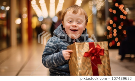 Smiling child with down syndrome with Christmas gifts in shopping bags at the mall. Christmas sale Smiling child with down syndrome with Christmas gifts in shopping bags at the mall. Christmas sale 107489653