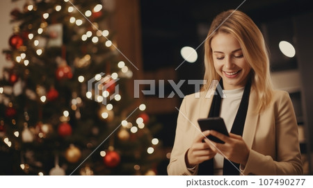 Christmas Businesswoman Using Smartphone in Office with Gifts Christmas Businesswoman Using Smartphone in Office with Gifts 107490277