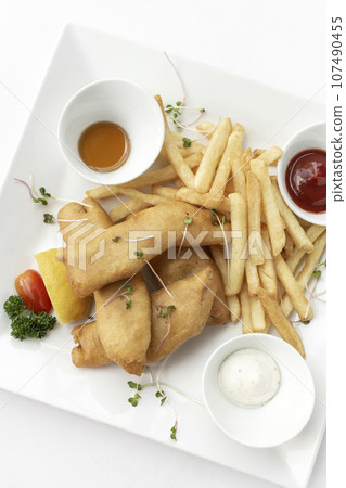 british traditional fish and chips meal in restaurant on white plate british traditional fish and chips meal in restaurant on white plate 107490455