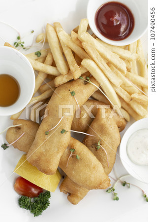 british traditional fish and chips meal in restaurant on white plate british traditional fish and chips meal in restaurant on white plate 107490456