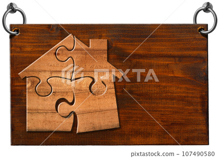 Wooden Sign with a Wooden House made of Puzzle Pieces Isolated on White Wooden Sign with a Wooden House made of Puzzle Pieces Isolated on White 107490580