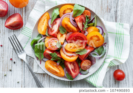 Green salad from leaves and tomatoes Green salad from leaves and tomatoes 107490893