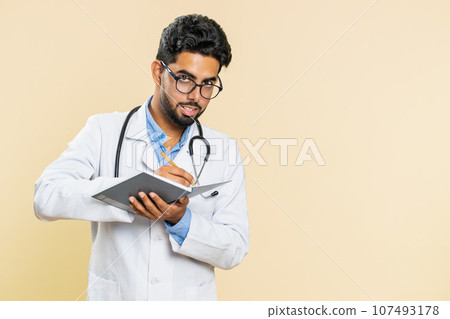 Doctor man making notes writing down thoughts with pen into notebook diary, to do list, good idea Doctor man making notes writing down thoughts with pen into notebook diary, to do list, good idea 107493178