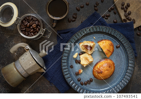 Pasticciotto leccese pastries on a plate near coffe cup and moka on dark table top view 107493541
