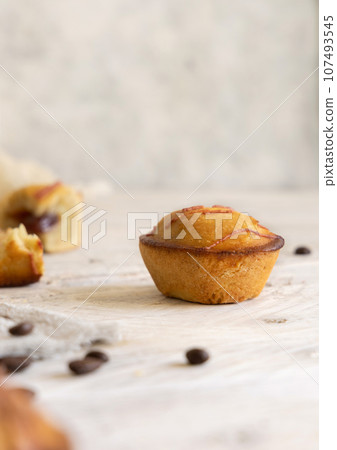 Pasticciotto leccese pastry filled with egg custard cream on a wooden table close up 107493545