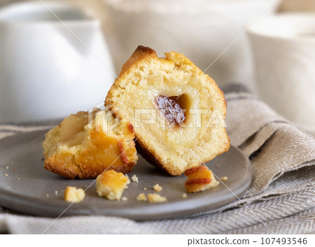 Pasticciotto leccese pastry filled with egg custard cream and sour cherry jam on a plate close up 107493546