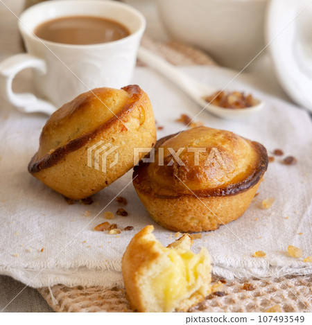 Pasticciotto leccese pastry filled with egg custard cream on a napkin close up Pasticciotto leccese pastry filled with egg custard cream on a napkin close up 107493549