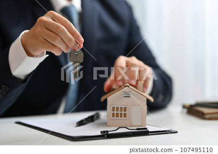 Realtor or bank manager holding keys. Real estate, property investment and loan concept 107495110
