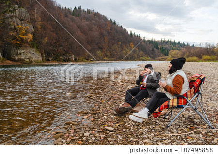 happy couple having picnic at river beach happy couple having picnic at river beach 107495858