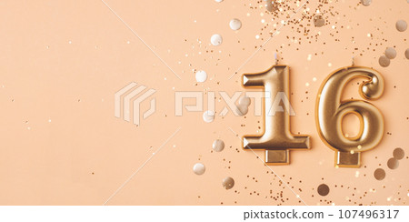 Gold candles in the form of number sixteen. Gold candles in the form of number sixteen. 107496317