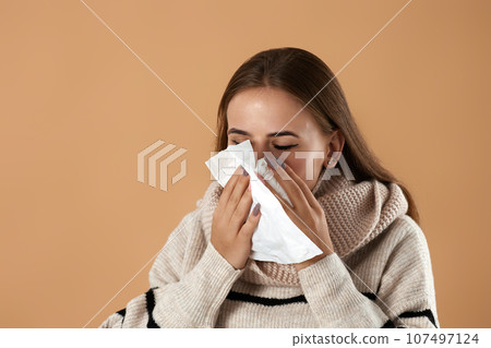 woman in sweater suffering from fever and flu 107497124
