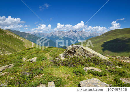Summer landscape in mountains and blue sky with clouds. Location place Alps, Europe. 107497326