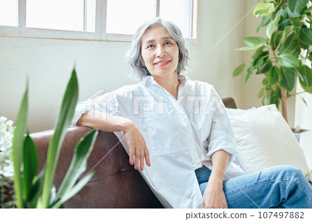 Senior woman relaxing on the sofa Senior woman relaxing on the sofa 107497882